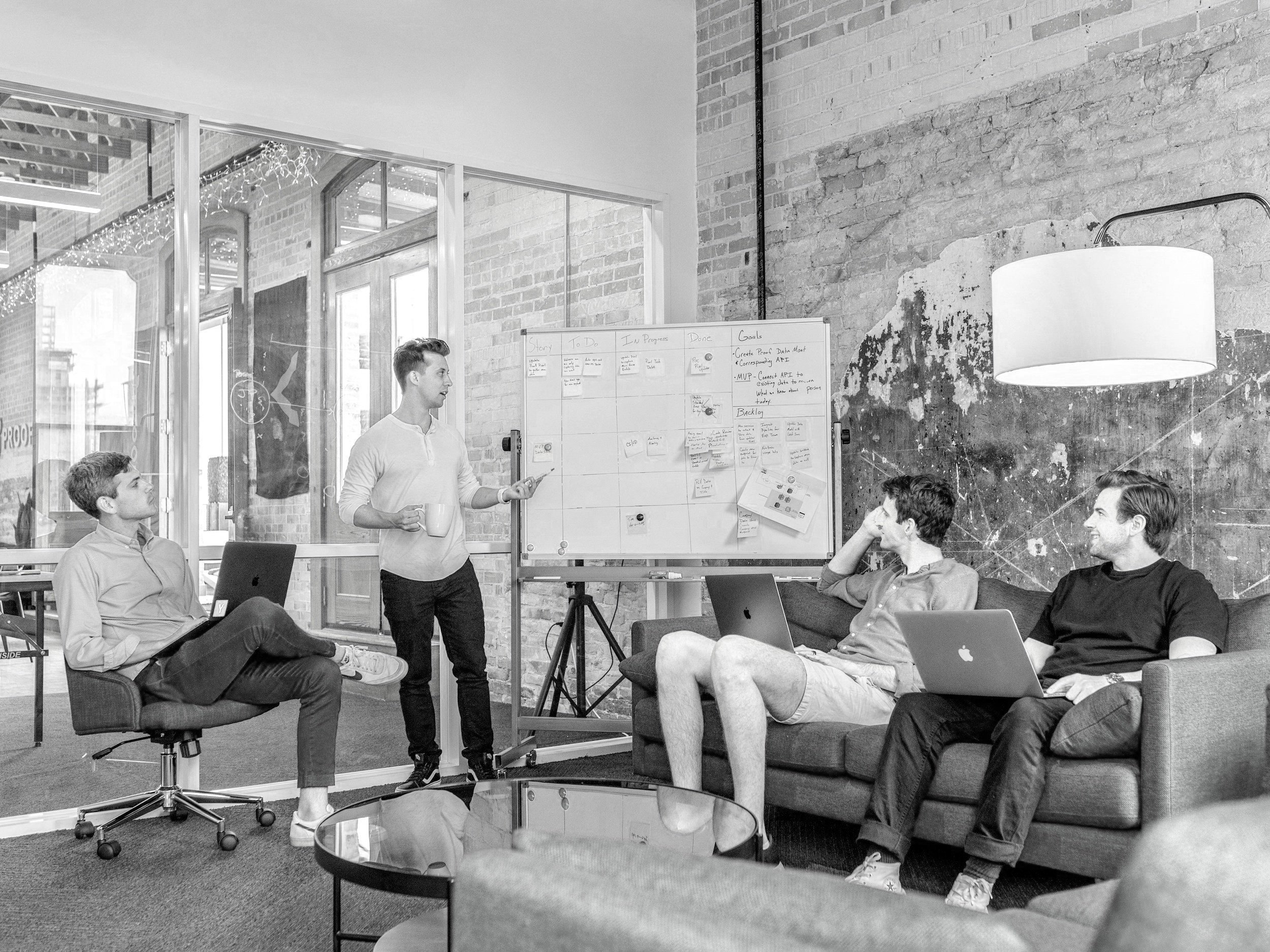 Product team reviewing a sprint board and roadmap on a whiteboard